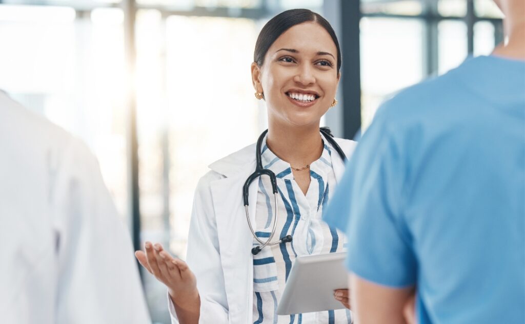 two healthcare workers having a discussion at a meeting