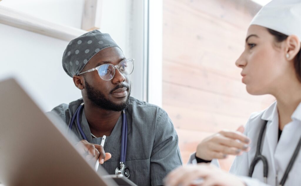 two Healthcare workers having a discussion at a meeting