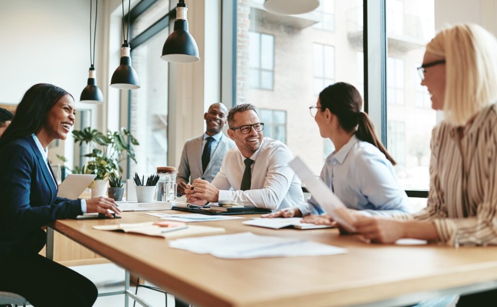 several people at a conference table during a meeting