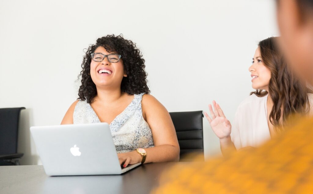 three people at a conference table during a meeting