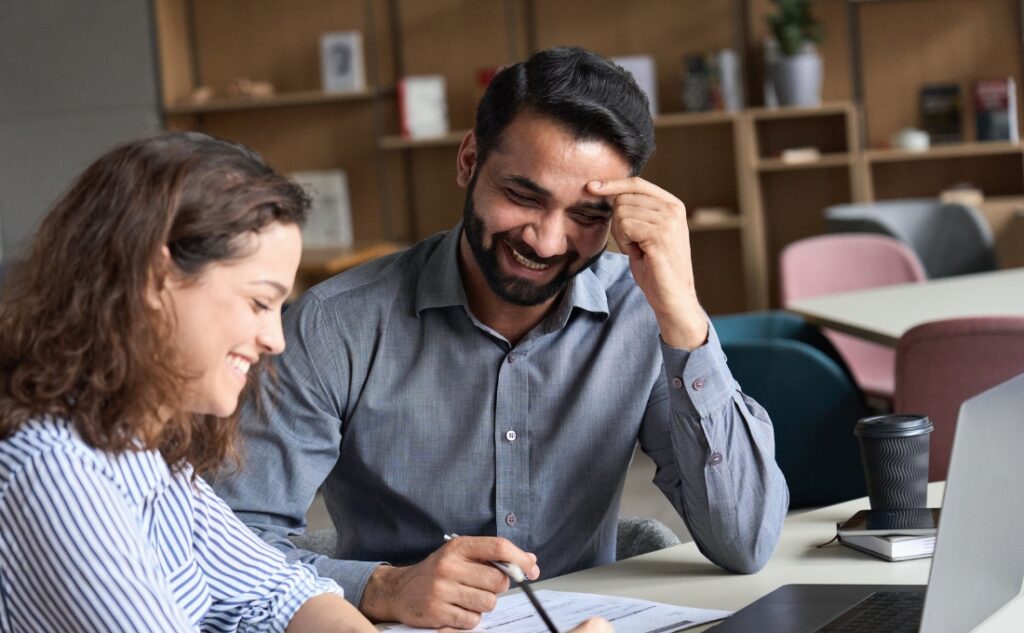 Two team members reviewing a document during a meeting