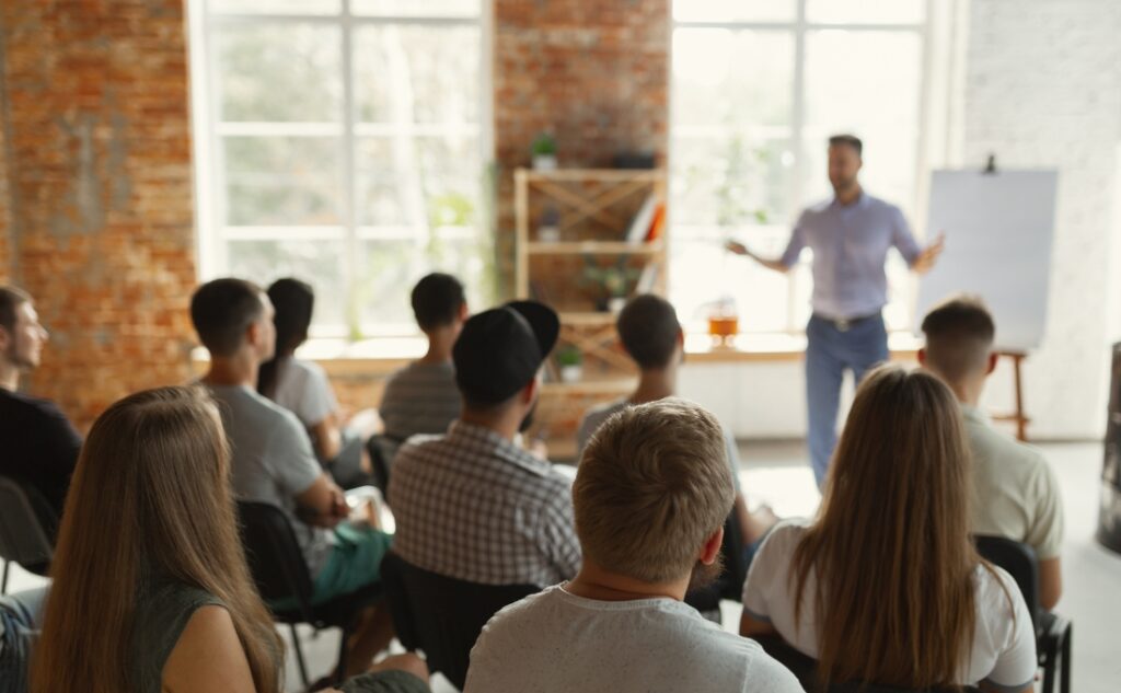 A person presenting to a group of people in an informal office setting