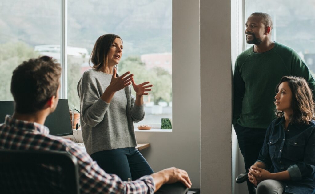 Several team members seen discussing an issue at an office setting